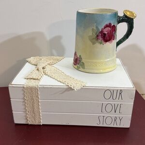 Rae Dunn Our Love Story" decorative book stack.